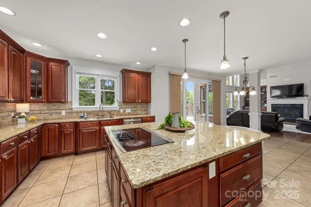 a kitchen with kitchen island granite countertop wooden cabinets and white appliances