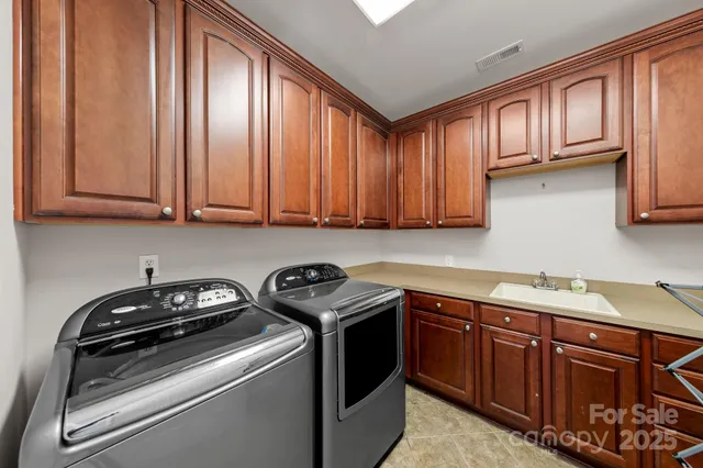 a kitchen with stainless steel appliances granite countertop wooden cabinets a stove a sink and dishwasher