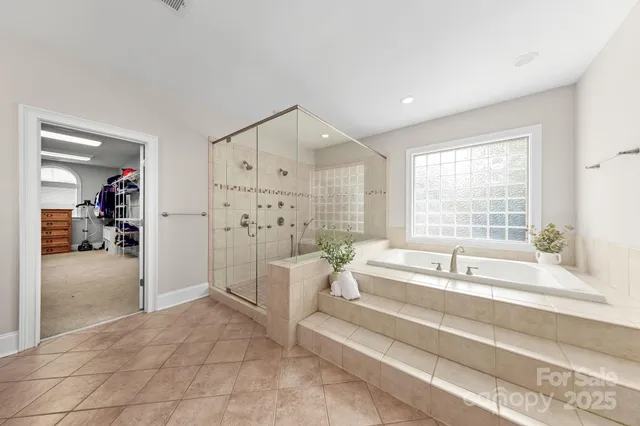 a spacious bathroom with a tub sink and shower
