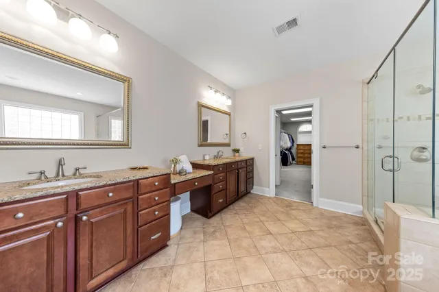 a spacious bathroom with a granite countertop sink mirror and a