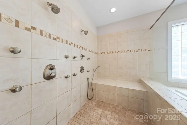 a bathroom with a bathtub and shower