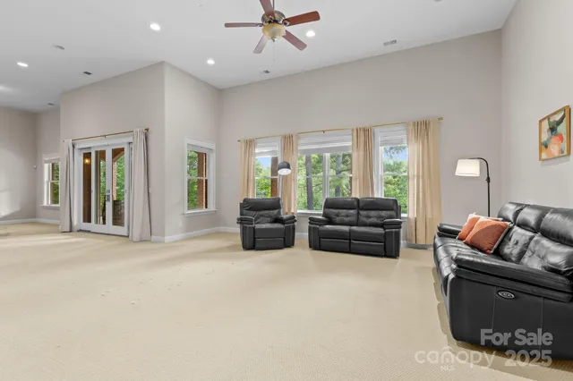 a living room with furniture and ceiling windows