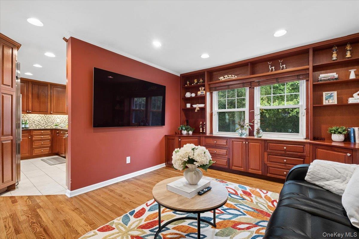 30 Stonehouse Road Scarsdale, NY 10583 - Photo 10 of 24 Family living area with extensive built-in cabinetry featuring plenty of open shelving and drawer storage.