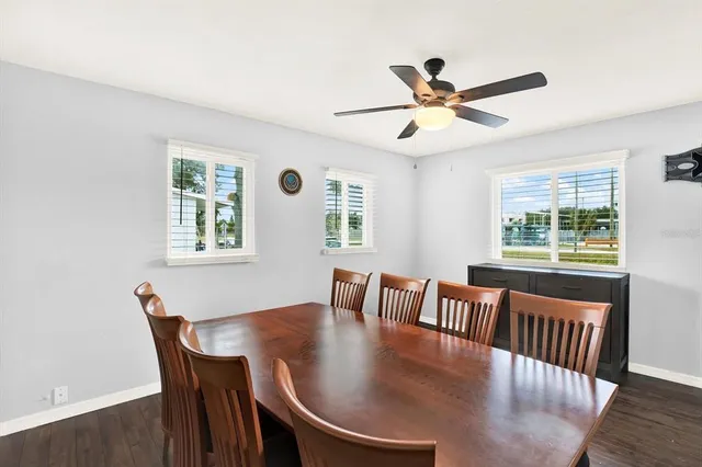 a view of a dining room with furniture window and wooden floor