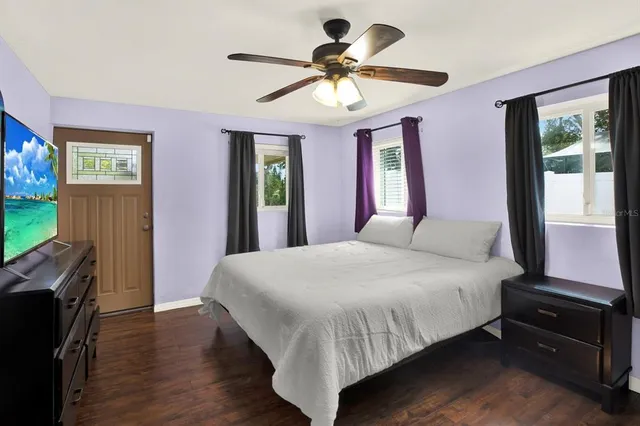 a bedroom with a bed and a flat screen tv