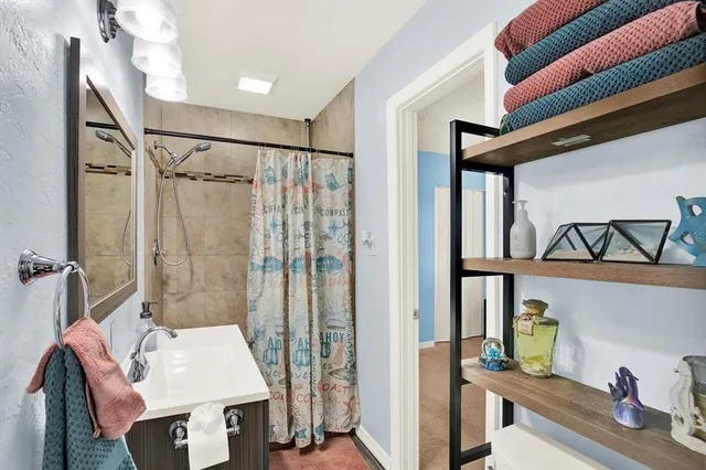 a bathroom with a shower curtain and a sink