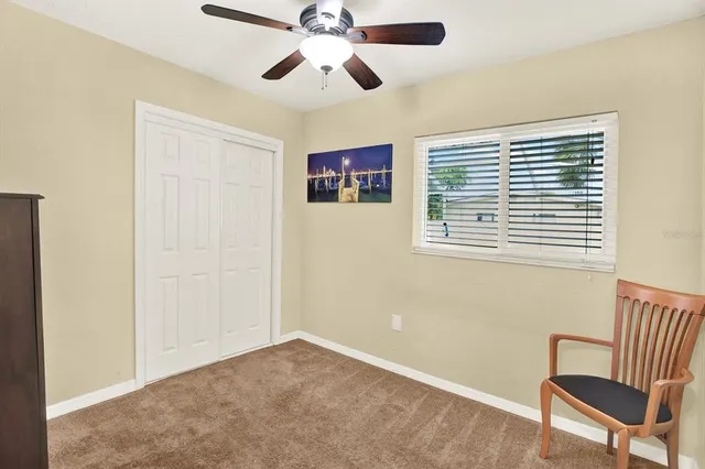 a view of room with a window and furniture