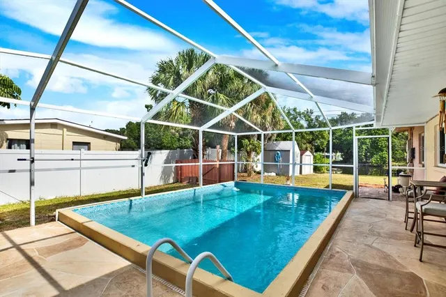 a view of a backyard with a swimming pool