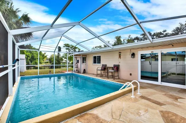 a view of a backyard with a swimming pool