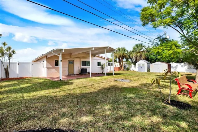 a view of a house with a backyard