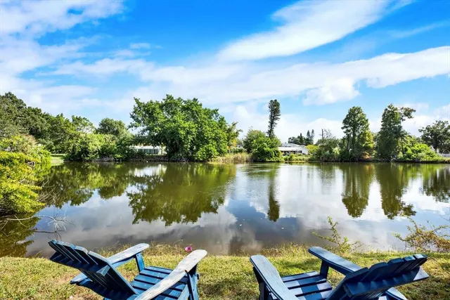 a view of a lake with houses in the background