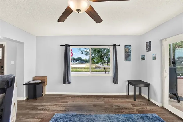 a view of a livingroom with a window and wooden floor