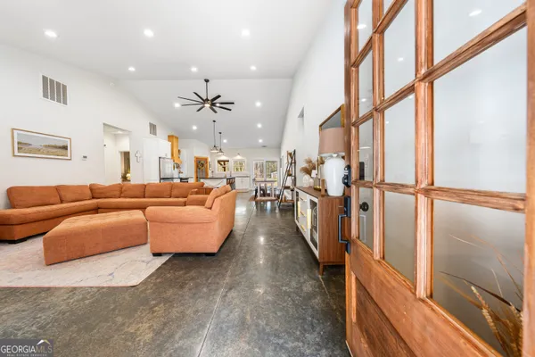a living room with furniture and a flat screen tv