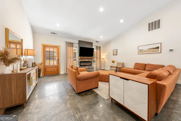 a living room with furniture and a flat screen tv
