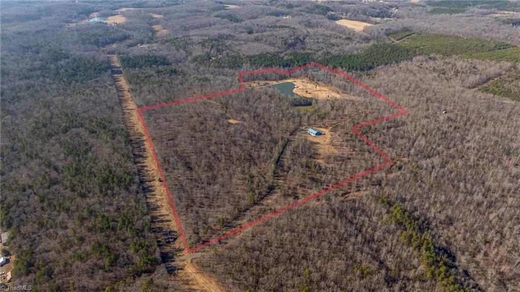 2117 Slate Mine Road Denton, NC 27239 - Photo 8 of 46 The locked red gate is located on Slate Mine Road. This is a shared private road with 2 other property owners and the acreage for sale begins just after crossing under the powerlines ahead.
