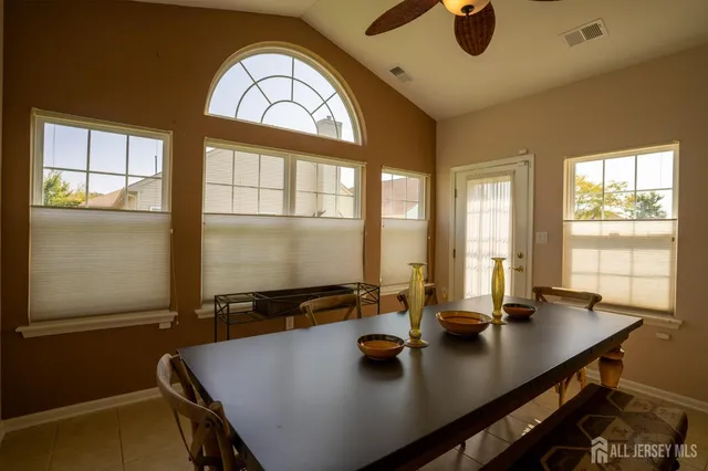 a view of a dining room with furniture and window