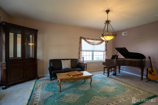 a living room with furniture rug and a window