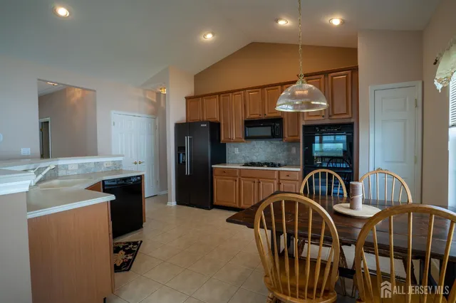 a kitchen with kitchen island a sink stove and cabinets