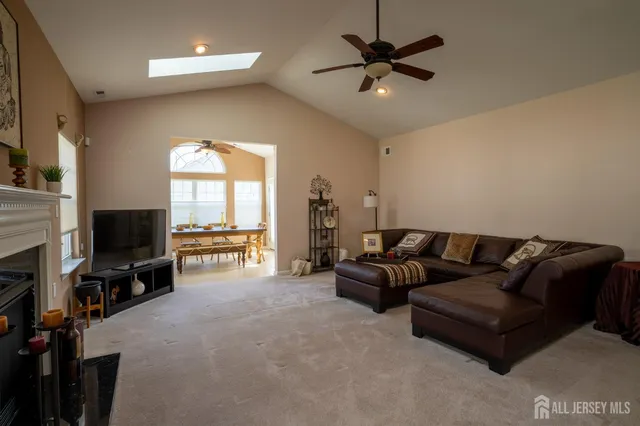 a living room with furniture a fireplace and a flat screen tv
