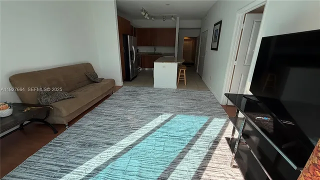 a living room with a couch and a rug