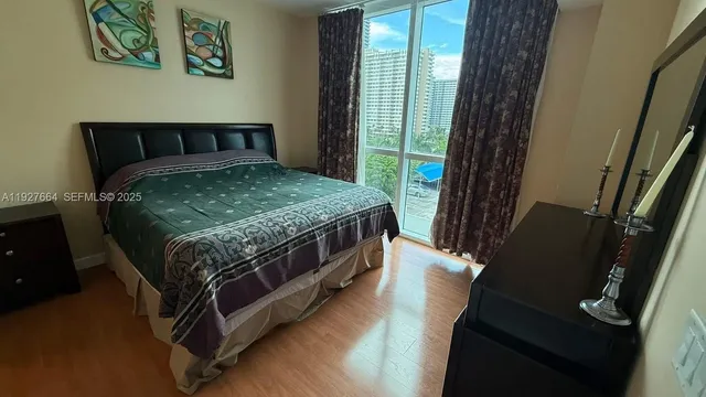 a bedroom with a bed next to a window