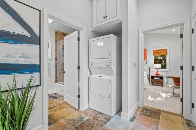 a bathroom with a granite countertop sink mirror vanity and toilet