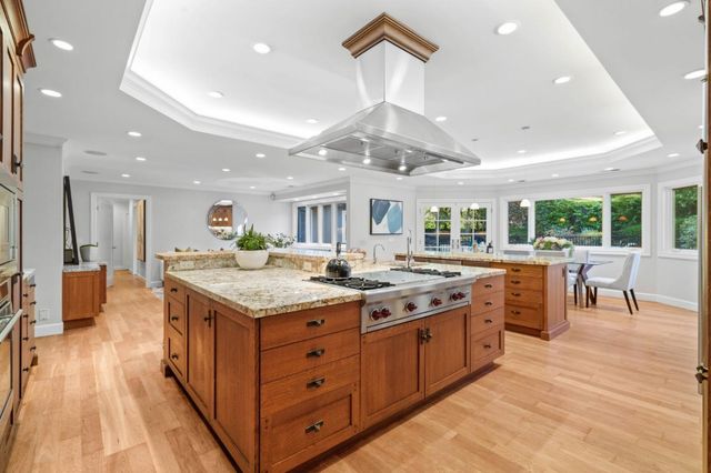 a kitchen with a stove and a wooden floor