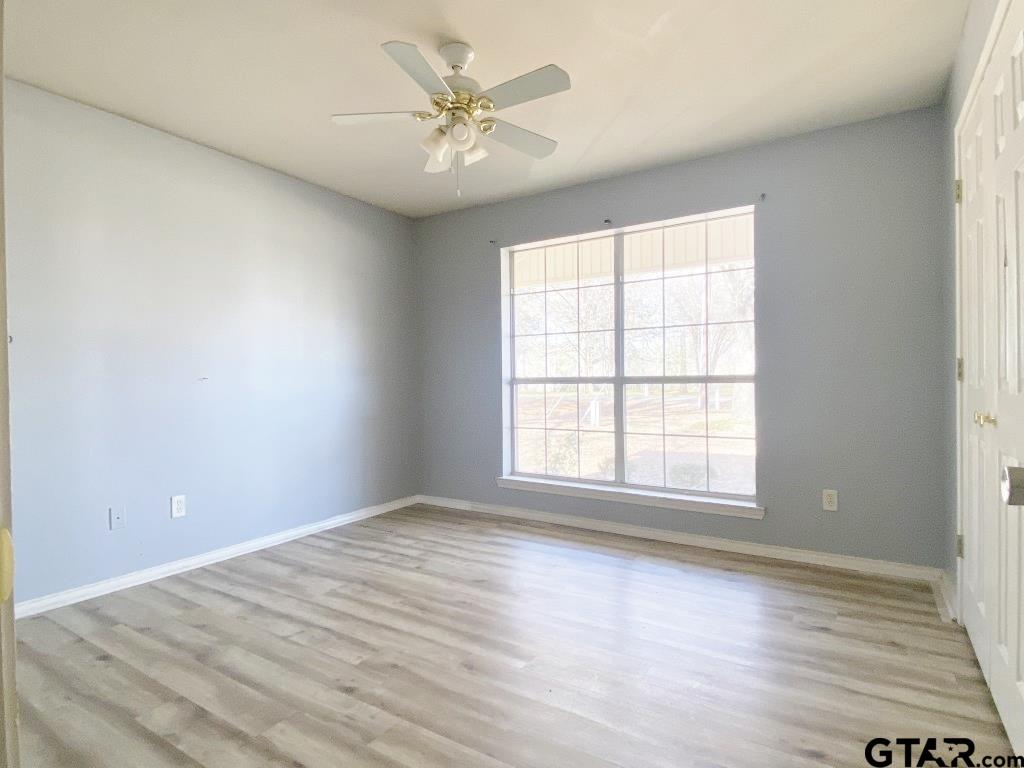 1707 Rotan Road Mount Pleasant, TX 75455 - Photo 13 of 18 an empty room with wooden floor and window