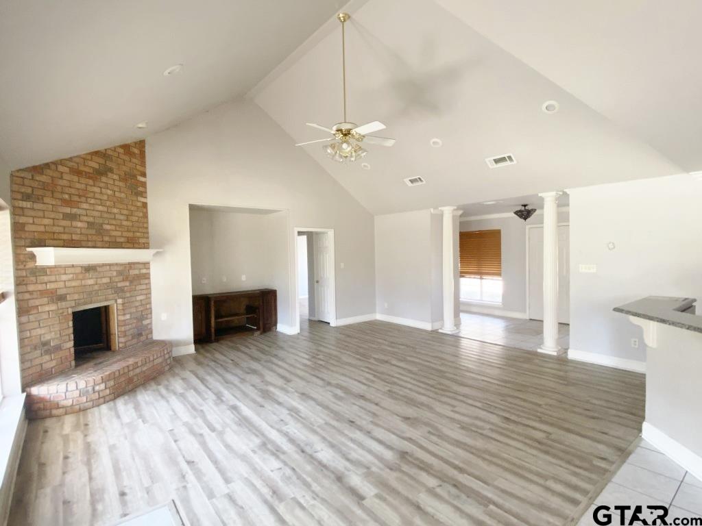 1707 Rotan Road Mount Pleasant, TX 75455 - Photo 2 of 18 a view of a livingroom with a fireplace a chandelier and stairs