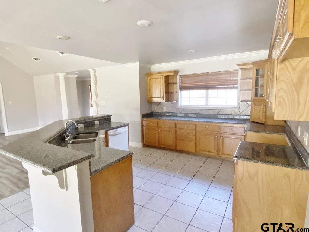 1707 Rotan Road Mount Pleasant, TX 75455 - Photo 5 of 18 a kitchen with a stove a sink a counter top space and cabinets