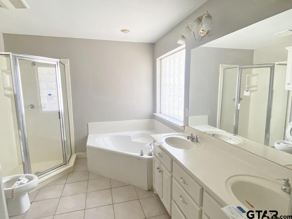 1707 Rotan Road Mount Pleasant, TX 75455 - Photo 9 of 18 a bathroom with a sink a toilet and shower
