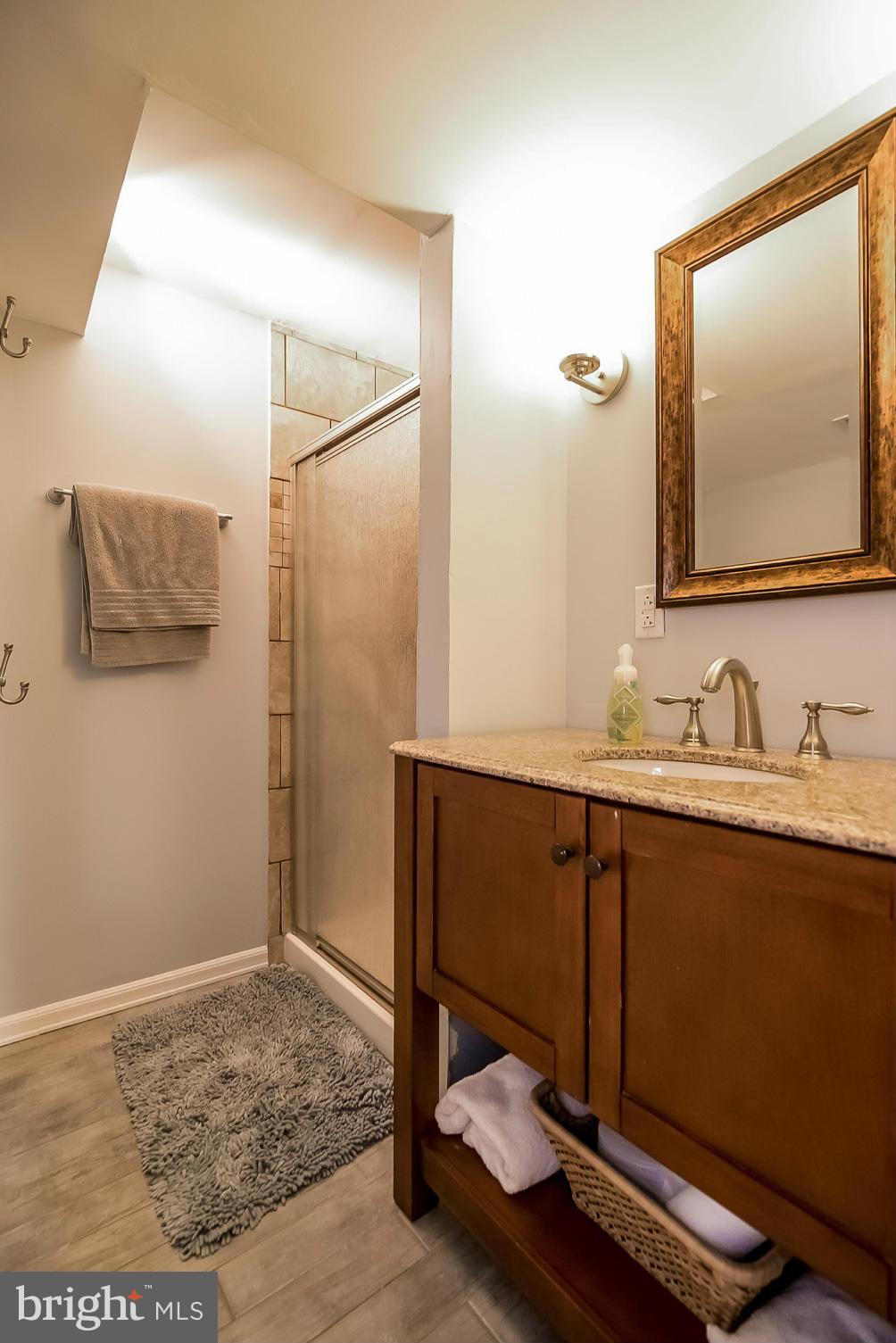8019 Old Receiver Road Frederick, MD 21702 - Photo 17 of 25 a bathroom with a sink mirror and vanity