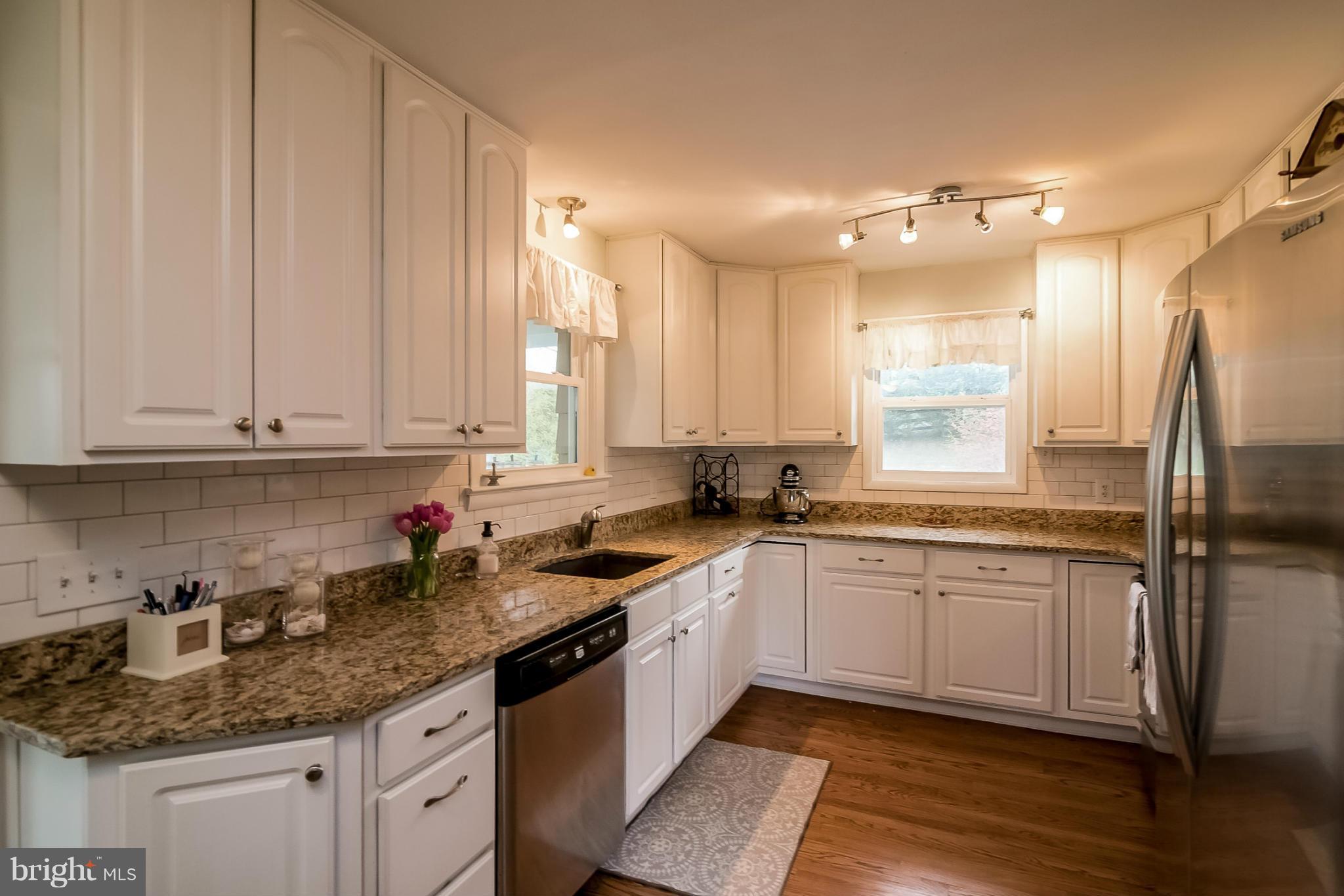 8019 Old Receiver Road Frederick, MD 21702 - Photo 4 of 25 a kitchen with stainless steel appliances granite countertop a sink stove and cabinets