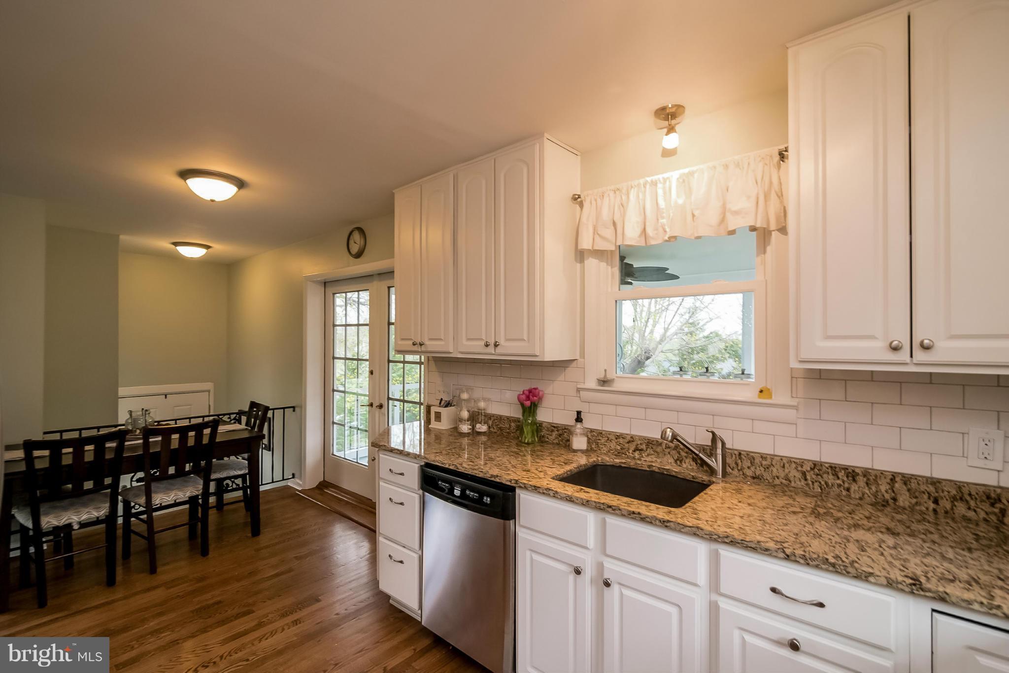 8019 Old Receiver Road Frederick, MD 21702 - Photo 7 of 25 a kitchen with granite countertop a sink a window and cabinets