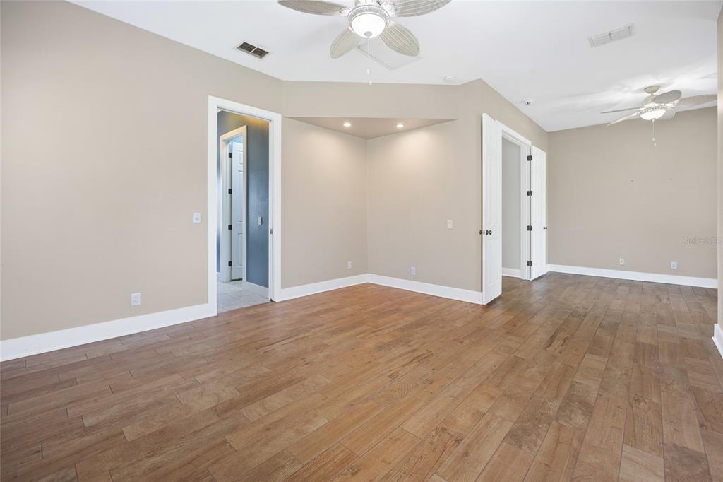 25 Southeast 69th Place Ocala, FL 34480 - Photo 16 of 52 wooden floor in an empty room with a window