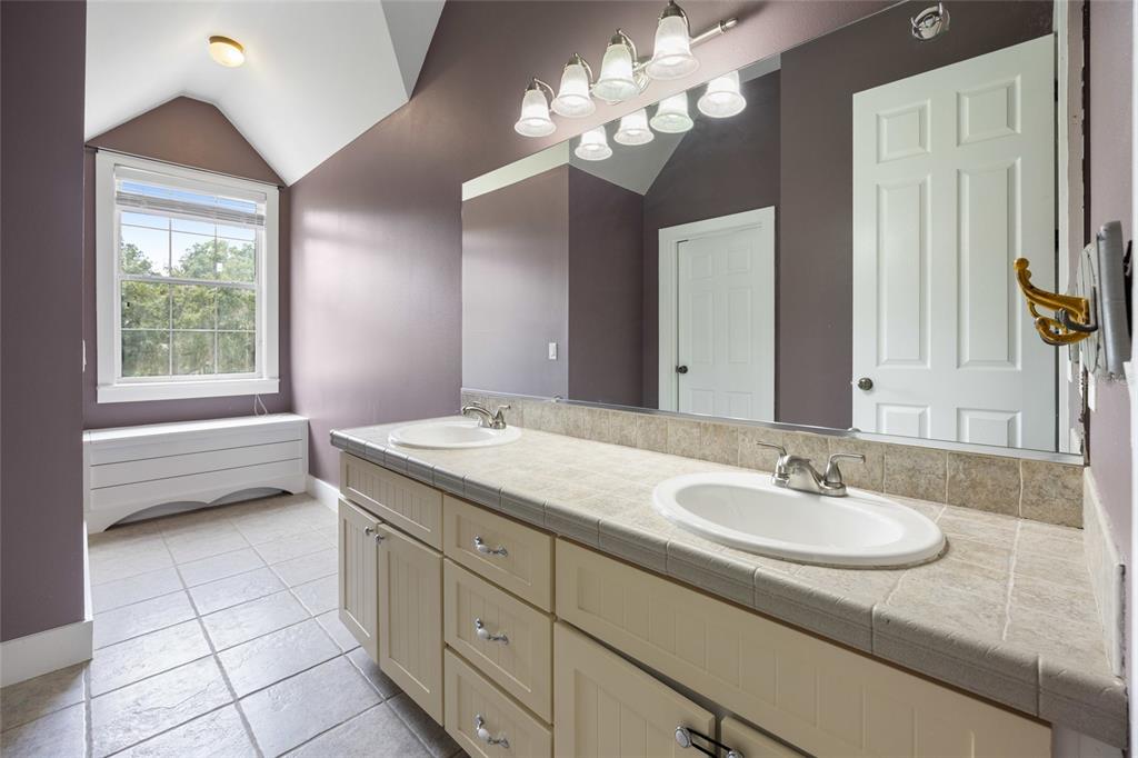 25 Southeast 69th Place Ocala, FL 34480 - Photo 28 of 52 a bathroom with a granite countertop sink a toilet and a mirror