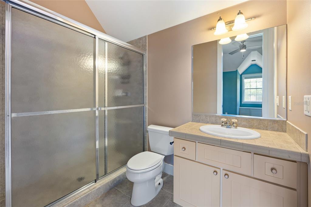 25 Southeast 69th Place Ocala, FL 34480 - Photo 32 of 52 a bathroom with a sink a toilet and shower