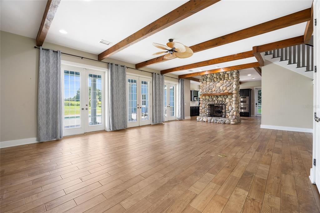 25 Southeast 69th Place Ocala, FL 34480 - Photo 5 of 52 an empty room with wooden floor and windows