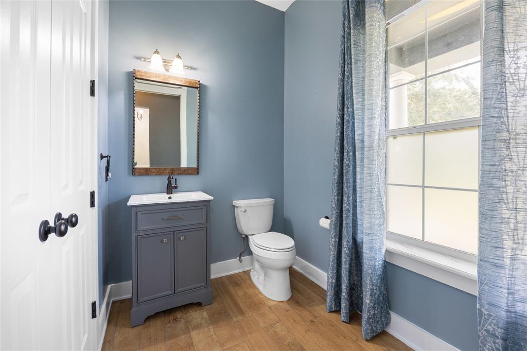 25 Southeast 69th Place Ocala, FL 34480 - Photo 7 of 52 a bathroom with a toilet sink and mirror