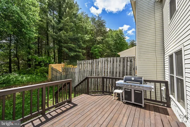 a view of a balcony with wooden floor and fence