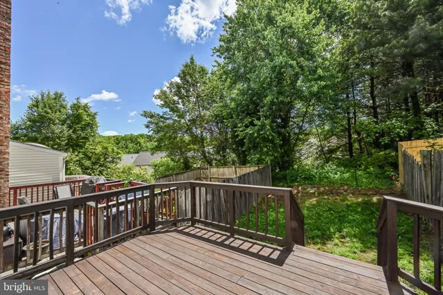 a view of balcony with wooden floor and fence