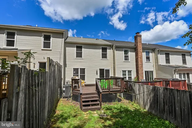 a front view of house with deck and outdoor seating