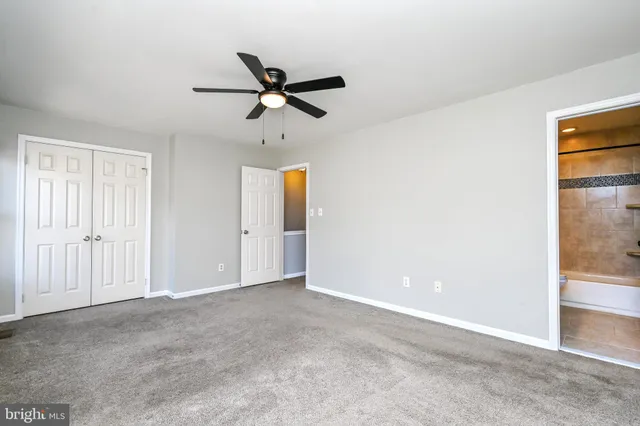 a bathroom with a bathtub shower sink vanity mirror and toilet