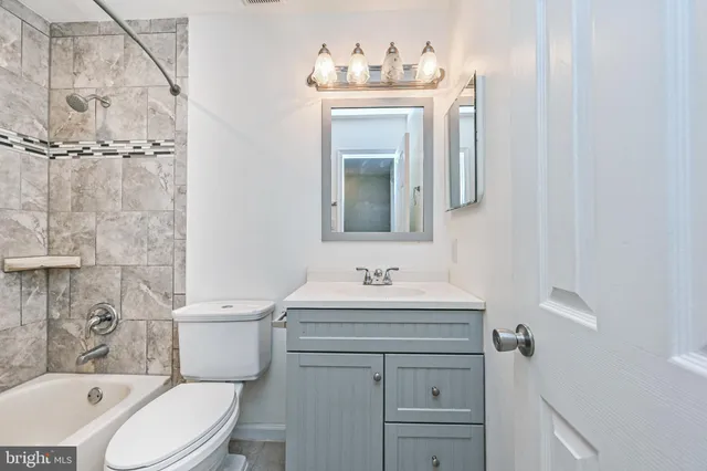 a bathroom with a toilet and a bathtub
