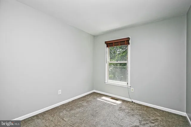 an empty room with closet and wooden door