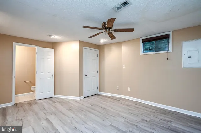 a view of an empty room and wooden floor