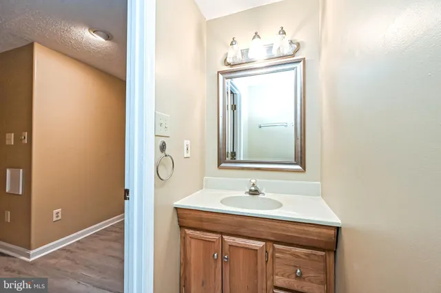 a bathroom with a sink a mirror and vanity