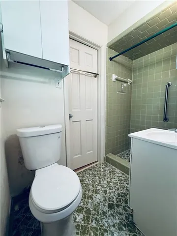 a white toilet sitting next to a bathroom sink