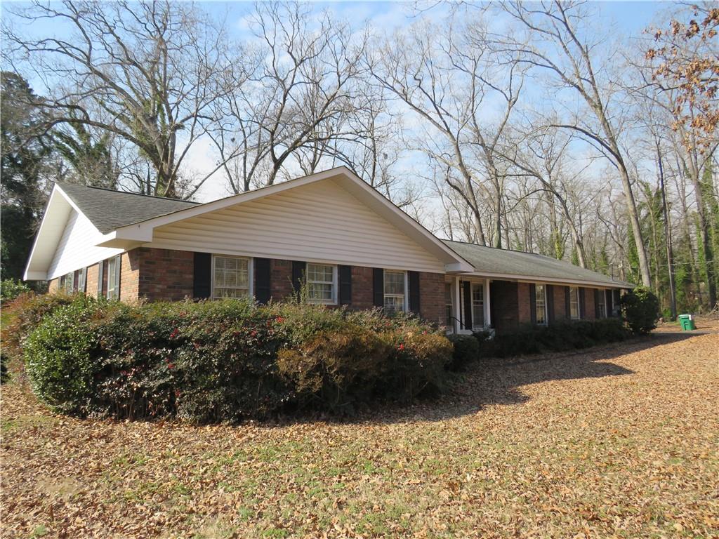 217 Cherokee Circle Cedartown, GA 30125 - Photo 3 of 25 a front view of a house with a garden