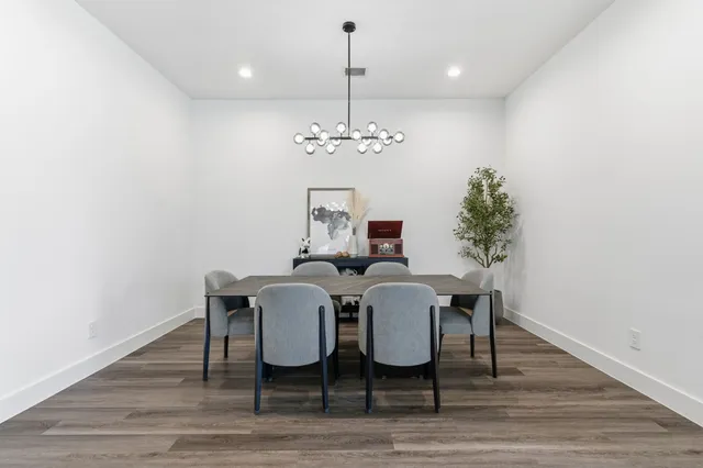 a view of a dining room with furniture wooden floor and chandelier